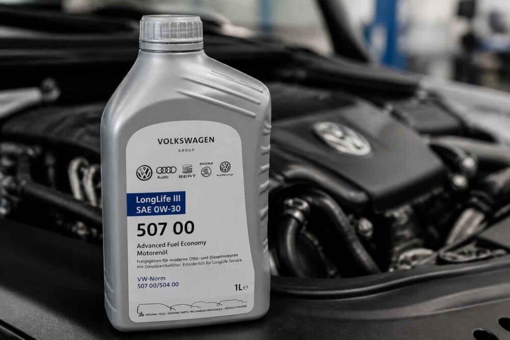 Butelka oleju Volkswagen LongLife III 0W-30 na tle silnika samochodowego