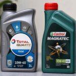Dwie butelki oleju silnikowego Total Quartz 7000 i Castrol Magnatec 10W-40 na stole